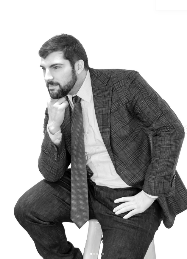 Charles Raimondo, seated, in a checked jacket